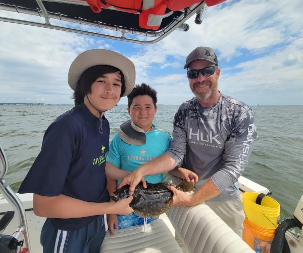 Young passengers showing off their catch
